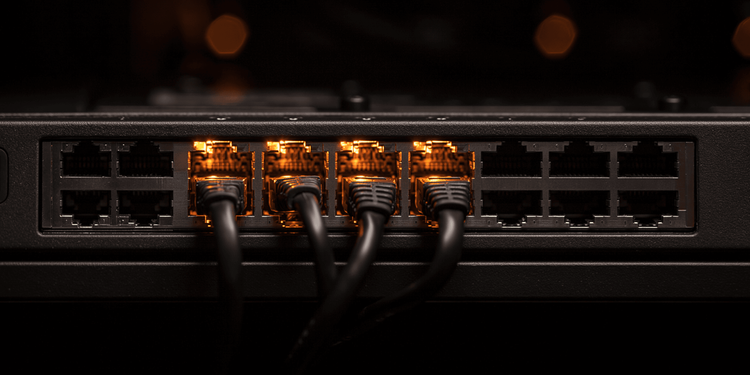 Fibre Channel switch ports with amber and blue link indicators in a dark storage rack